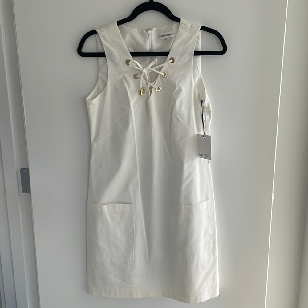 Calvin Klein new white shift dress with front pockets and tie front